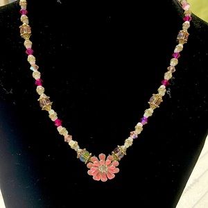 Handmade necklace with pink flower pendant.